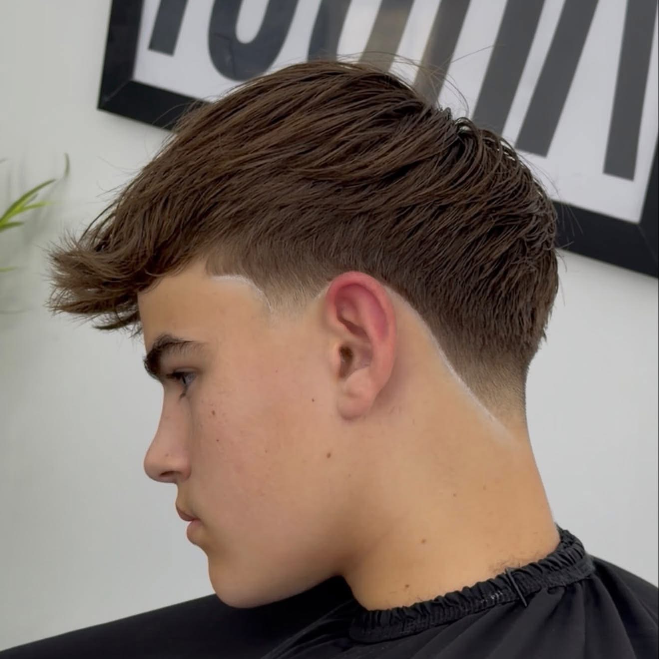 Side profile of a textured taper haircut